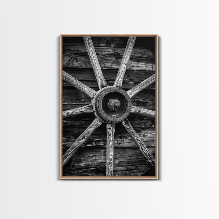 Rustic wagon wheel against wooden background, black and white Western decor Framed Canvas Print, vintage wall art for home living room decor