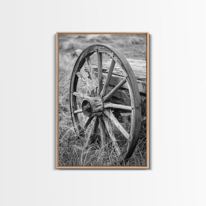 Weathered wagon wheel in tall grass, black and white photography, Framed Canvas Print, rustic Western decor, vintage wall art for home