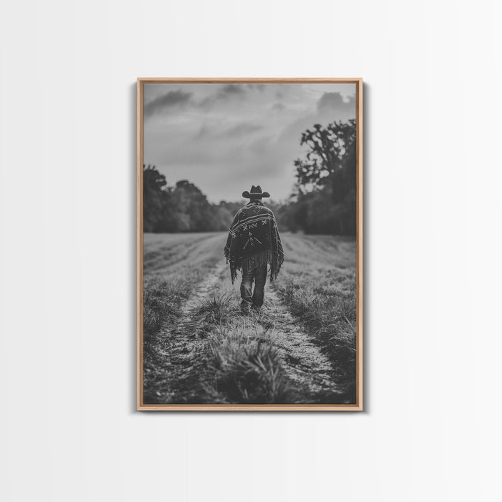 Lone cowboy walking on dirt path, black and white photography, Framed Canvas Print, rustic Western decor, vintage wall art for home