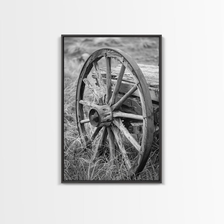 Weathered wagon wheel in tall grass, black and white photography, Framed Canvas Print, rustic Western decor, vintage wall art for home