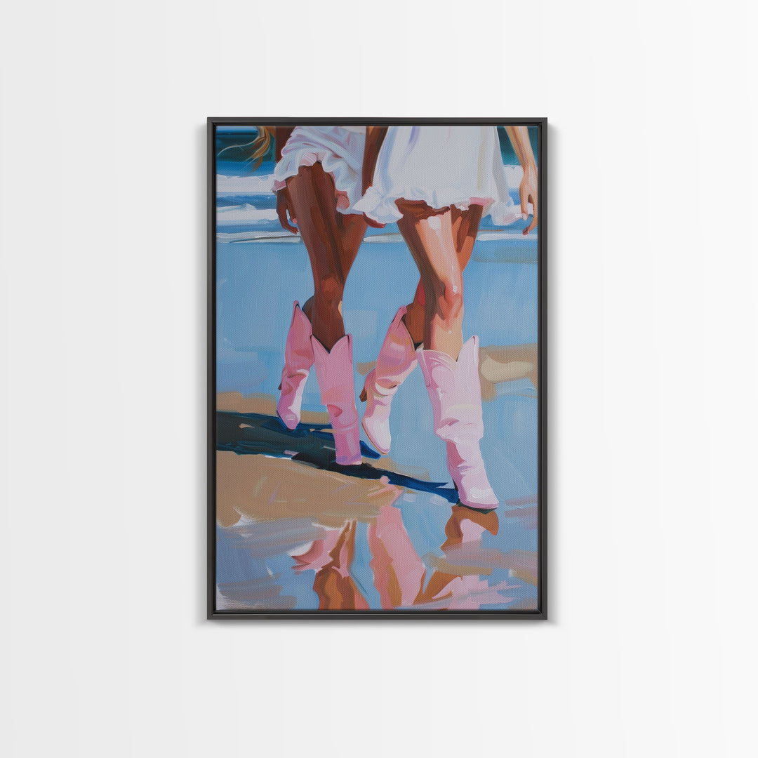 Two women wearing pink cowboy boots walking on the beach, reflections in sand Framed Canvas Print - beach decor, fashion art, summer vibes