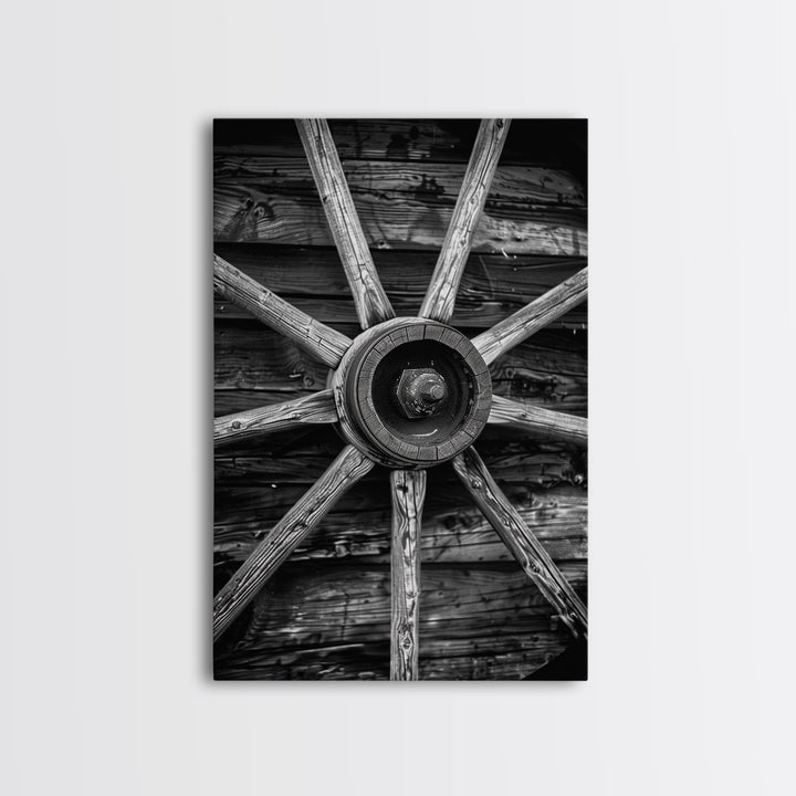 Rustic wagon wheel against wooden background, black and white Western decor Framed Canvas Print, vintage wall art for home living room decor