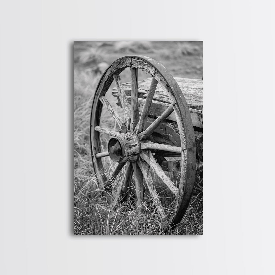 Weathered wagon wheel in tall grass, black and white photography, Framed Canvas Print, rustic Western decor, vintage wall art for home