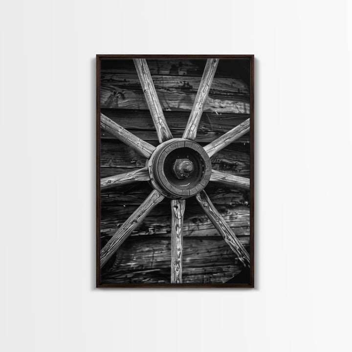 Rustic wagon wheel against wooden background, black and white Western decor Framed Canvas Print, vintage wall art for home living room decor