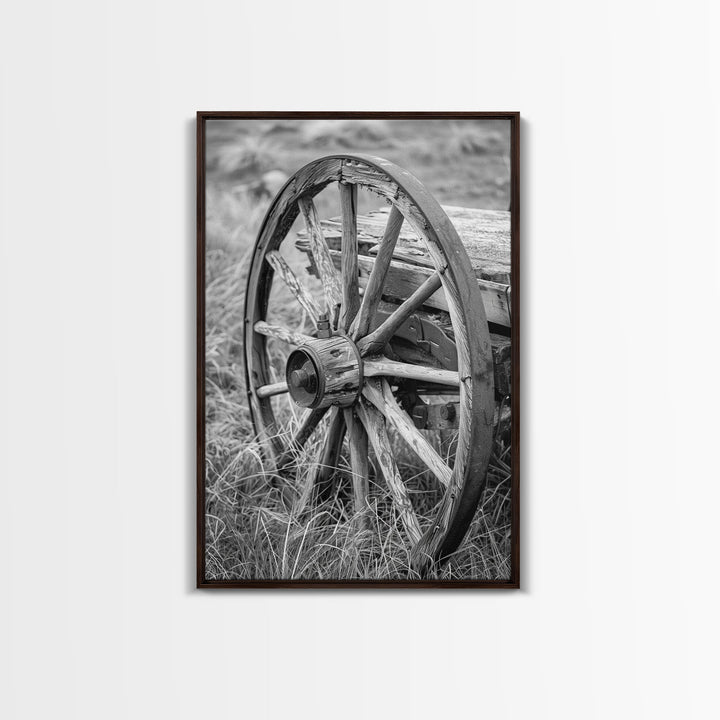 Weathered wagon wheel in tall grass, black and white photography, Framed Canvas Print, rustic Western decor, vintage wall art for home