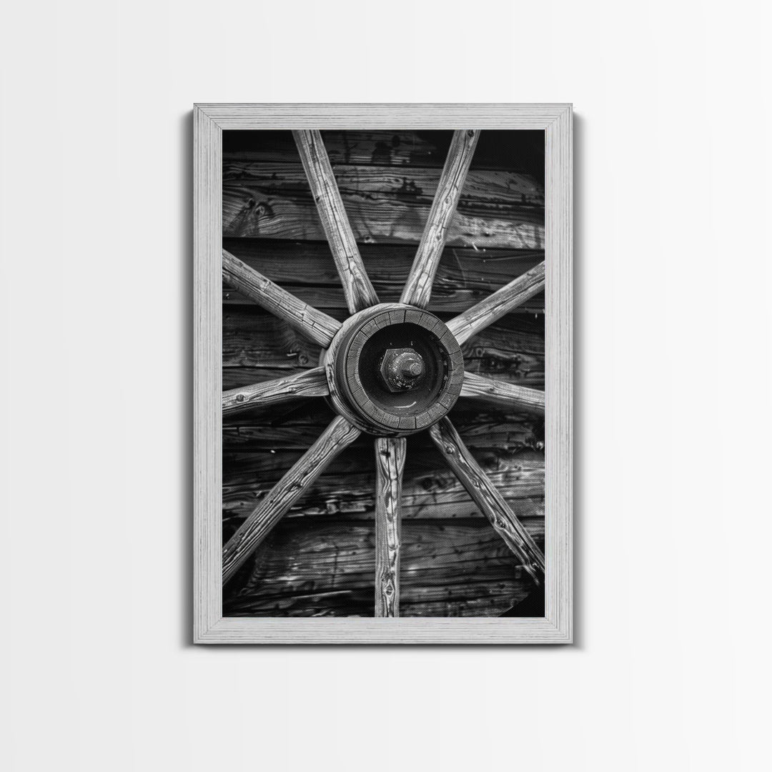 Rustic wagon wheel against wooden background, black and white Western decor Framed Canvas Print, vintage wall art for home living room decor