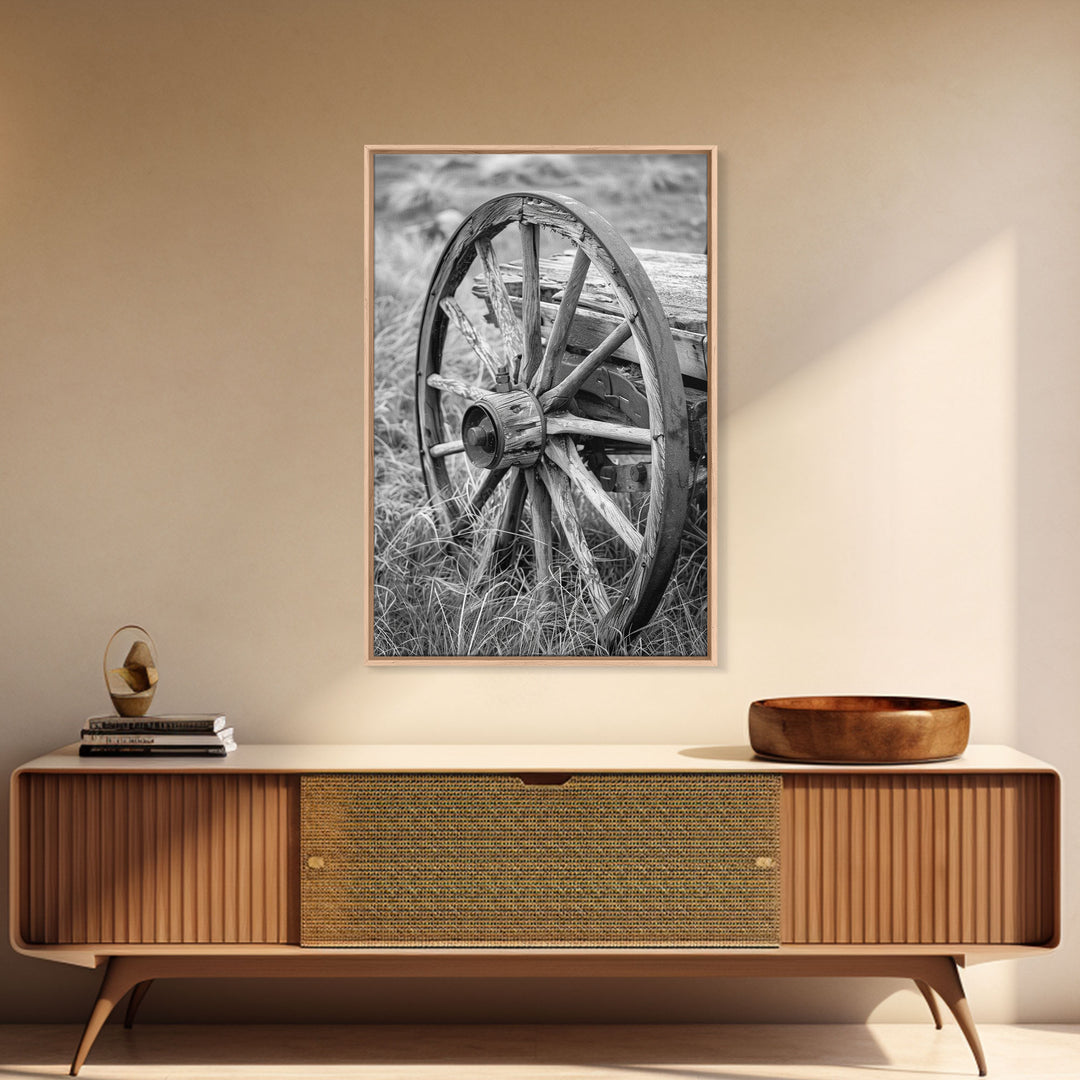 Weathered wagon wheel in tall grass, black and white photography, Framed Canvas Print, rustic Western decor, vintage wall art for home