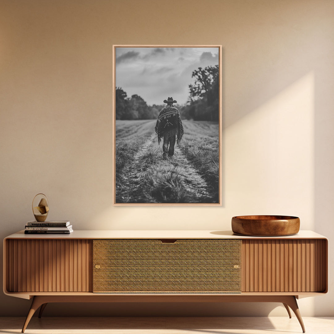 Lone cowboy walking on dirt path, black and white photography, Framed Canvas Print, rustic Western decor, vintage wall art for home